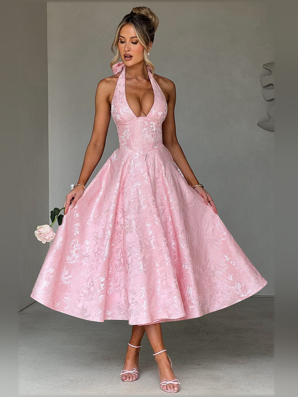 Blush halter midi formal dress with deep V neckline and flared skirt, fitted bodice