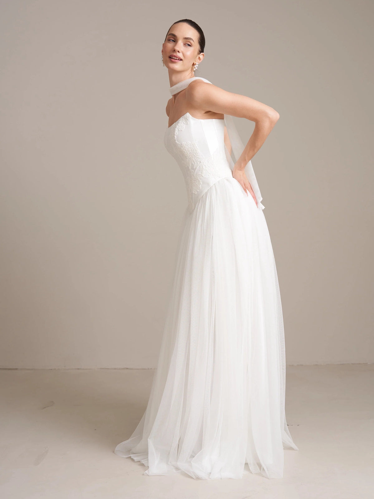 Ivory strapless satin wedding dress with draped corset and A-line tulle skirt