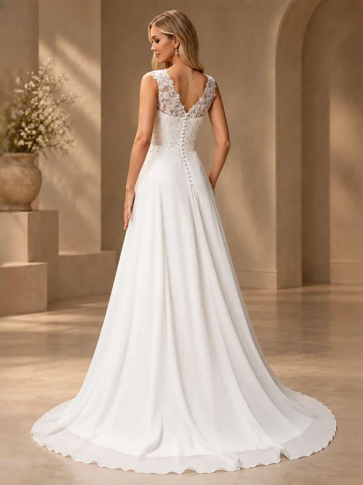 White wedding dress with lace V-back, sleeveless straps, and A-line floor-length skirt