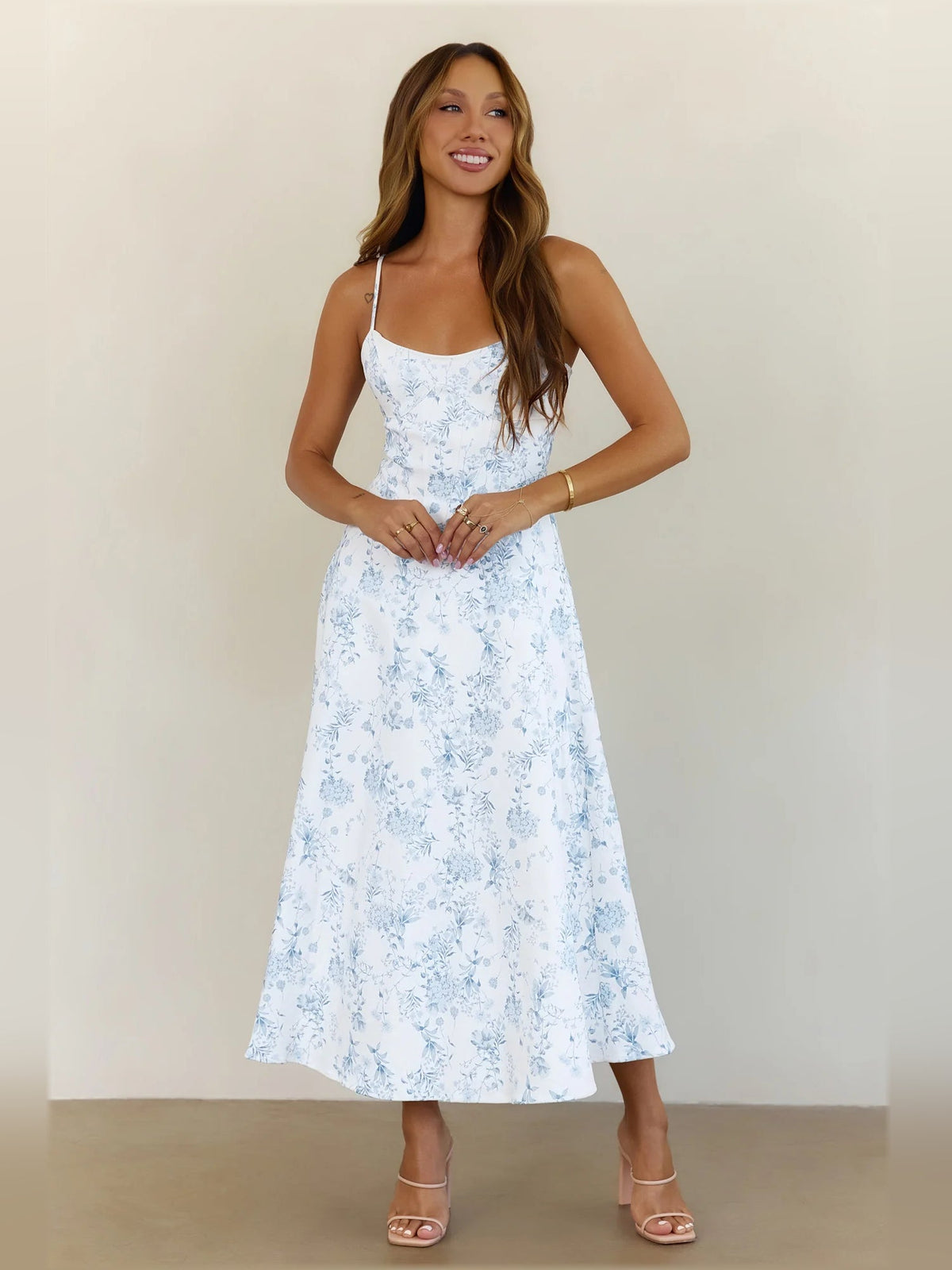 Light blue floral midi dress with spaghetti straps, fitted bodice, A-line skirt
