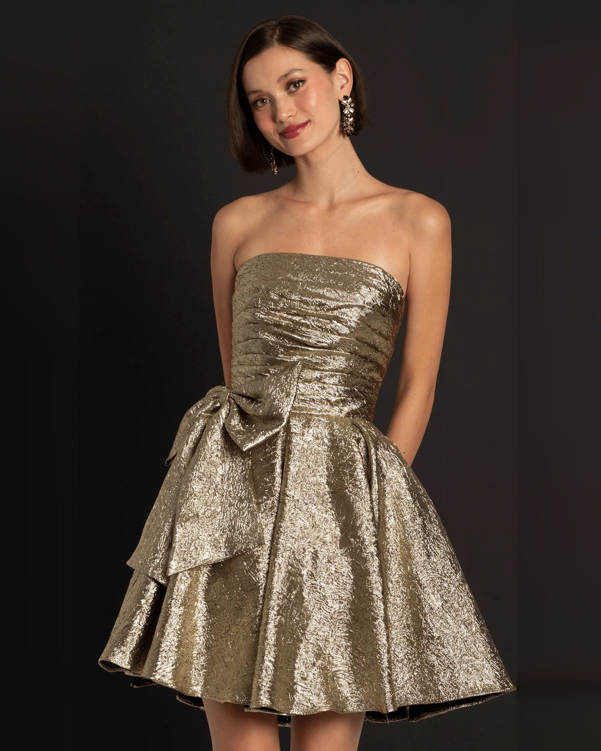 Gold strapless ruched fit-and-flare dress with pleated skirt and waist bow detail
