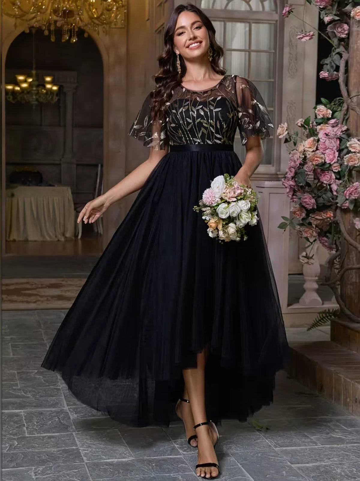 Black A-line maxi prom dress with embroidered ruffled short sleeves and tiered tulle skirt.