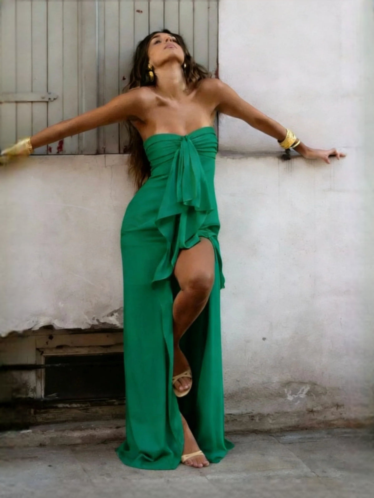 Green strapless satin sheath prom dress with draped bow and thigh-high slit