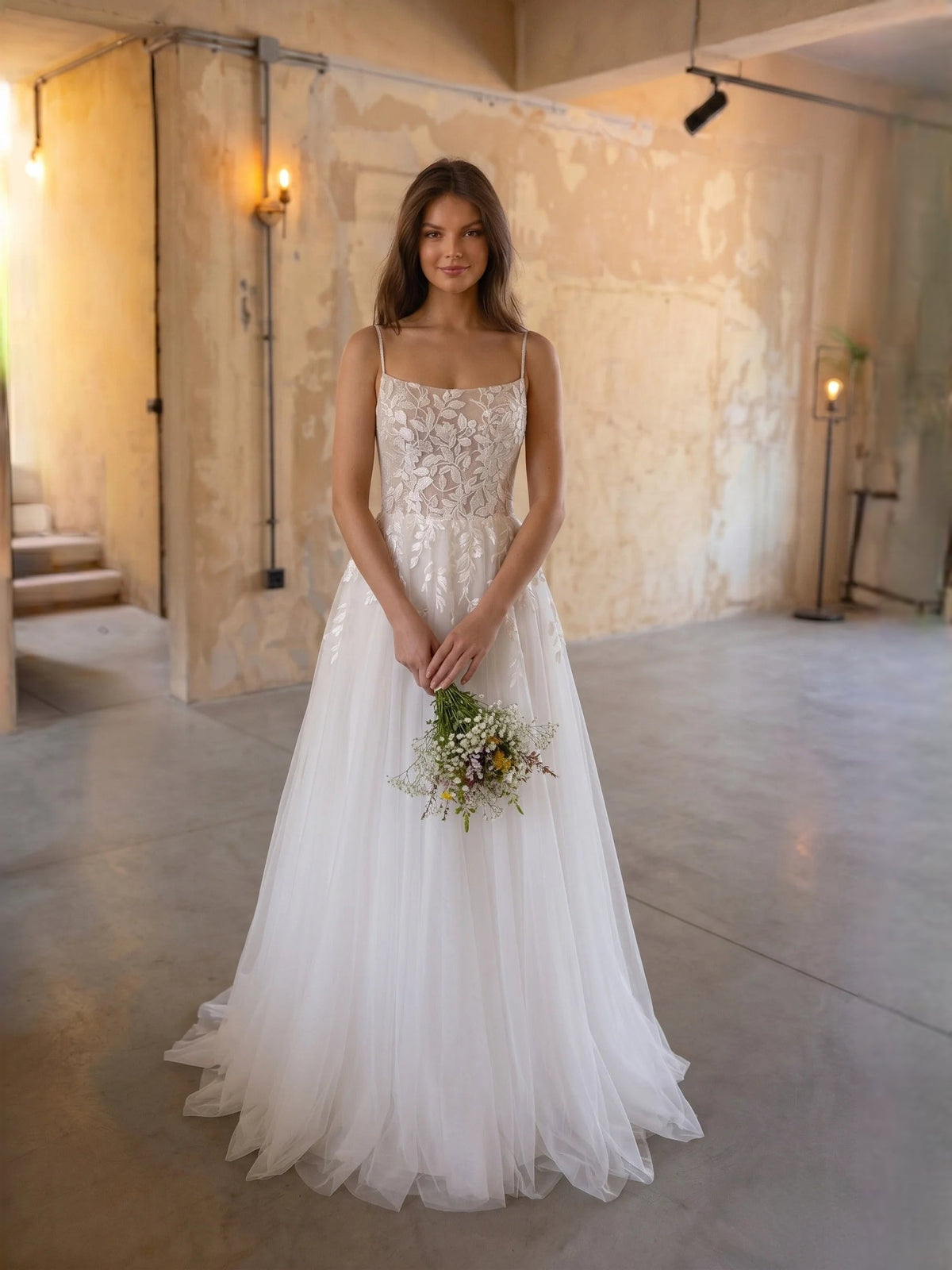 Ivory floral lace square-neck A-line tulle wedding dress with spaghetti straps, floor-length.