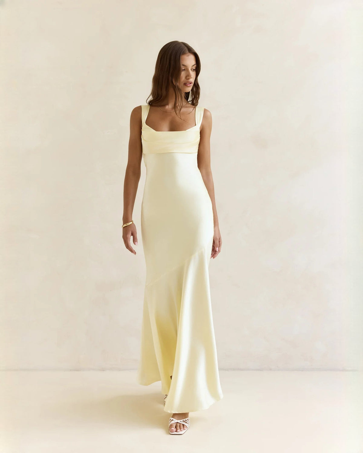 Sleeveless satin A-line maxi dress in pale yellow with square neckline and thin straps