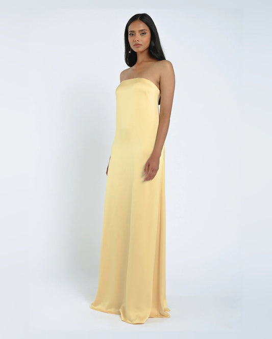 Yellow strapless satin A-line maxi dress with fitted bodice and flowing skirt.
