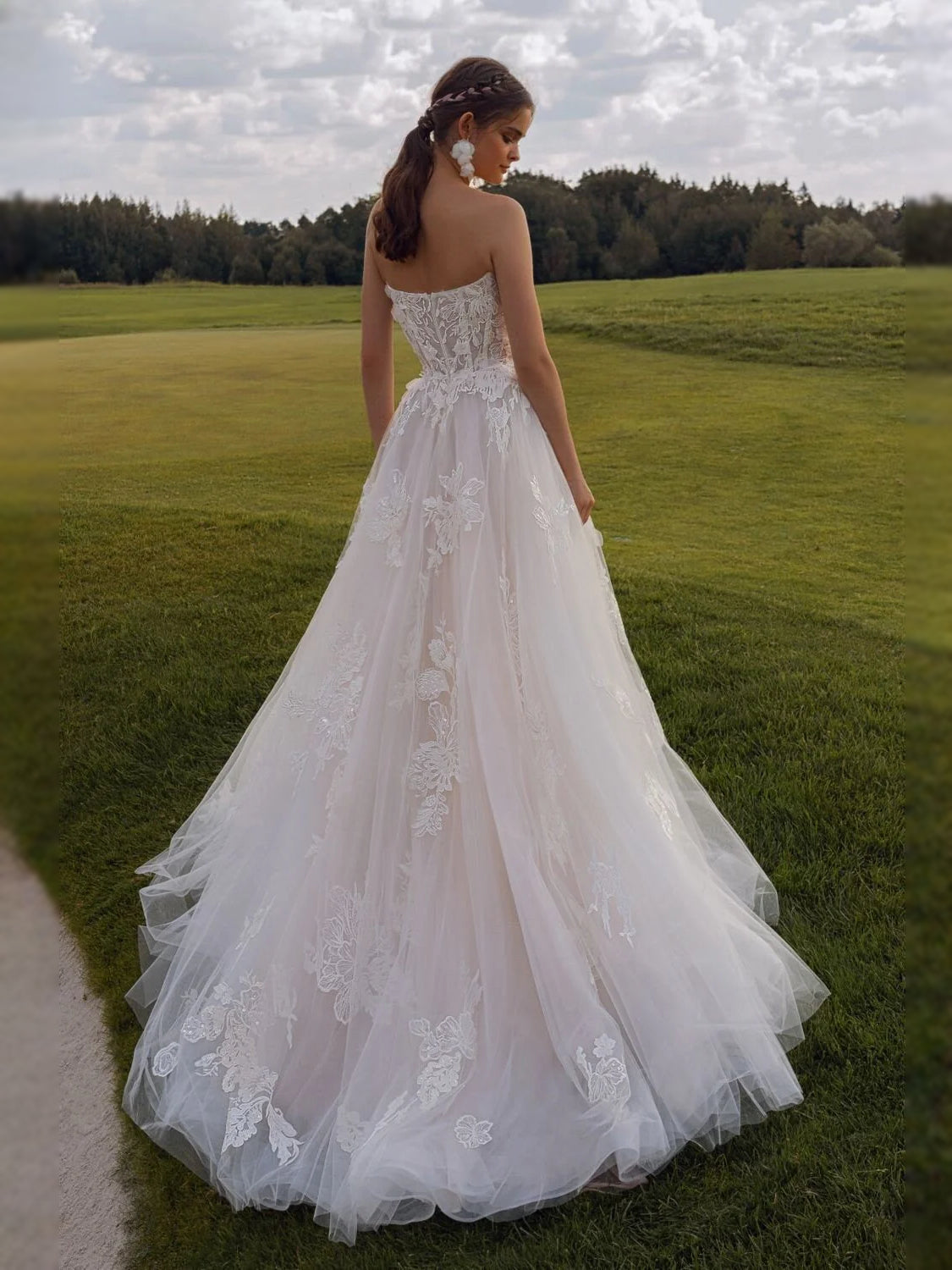Ivory strapless bridal gown with floral lace appliques and full tulle skirt, back view