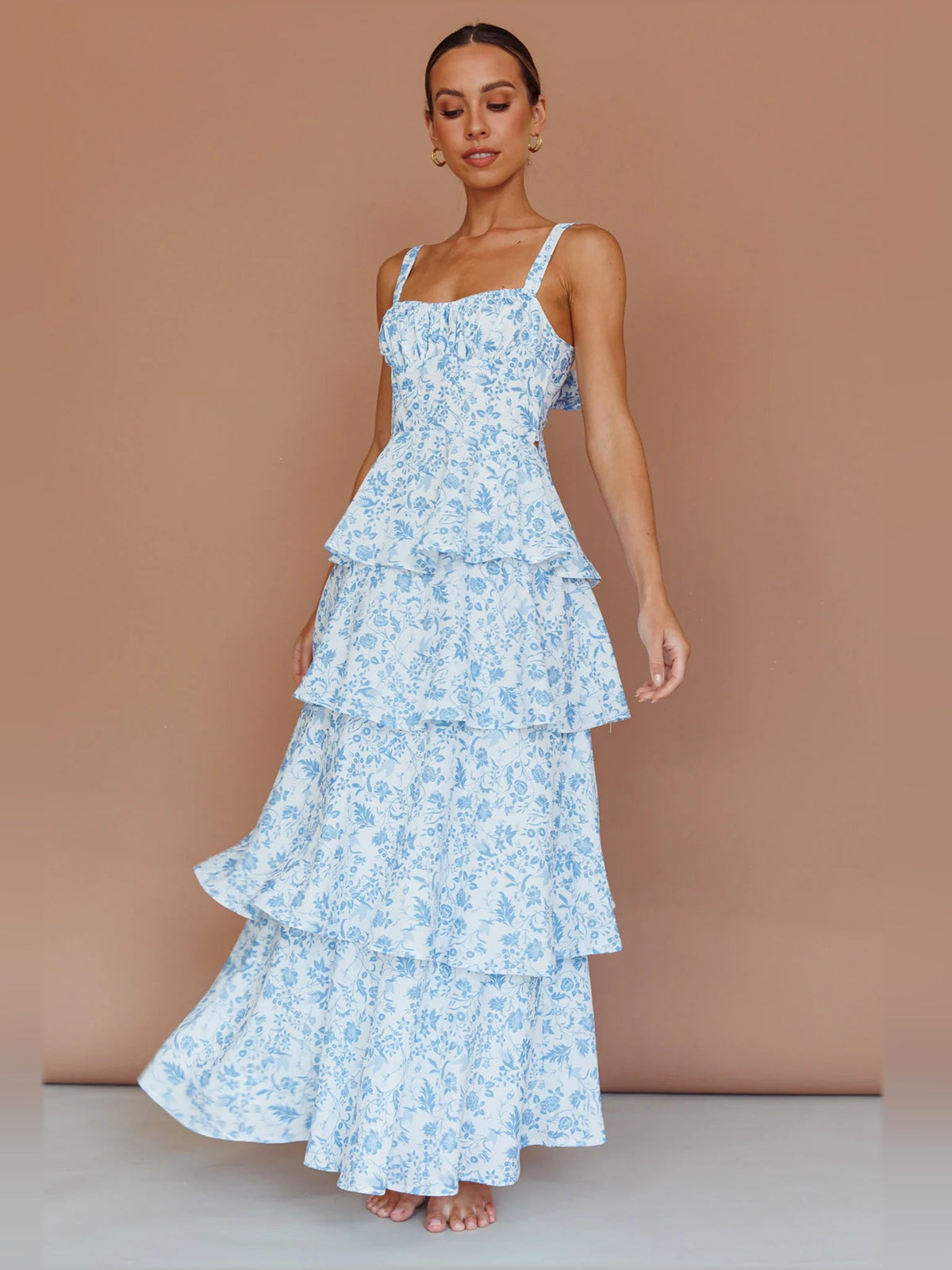 Blue floral tiered midi dress with square neckline and thin spaghetti straps