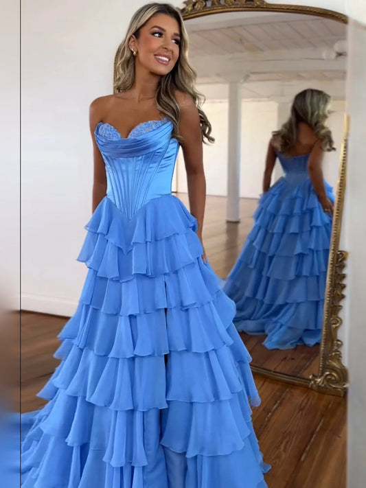Blue strapless corset prom dress with tiered ruffle skirt, floor-length.