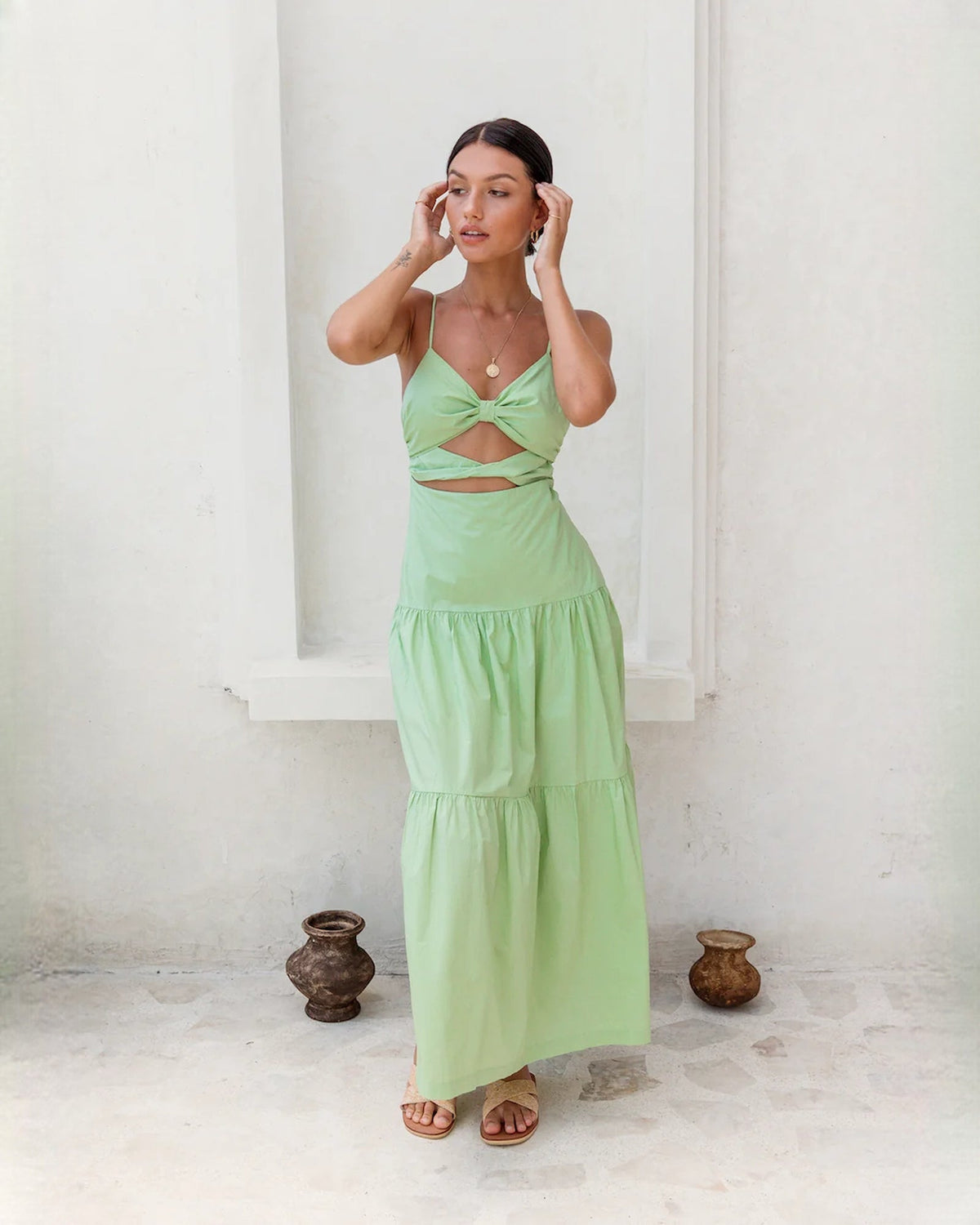 Light green sleeveless tiered maxi dress with knot detail at the bust
