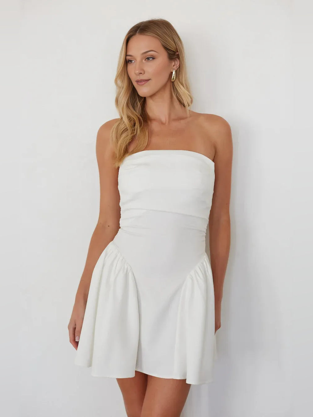 White strapless mini A-line dress with ruched bodice and flared pleated skirt