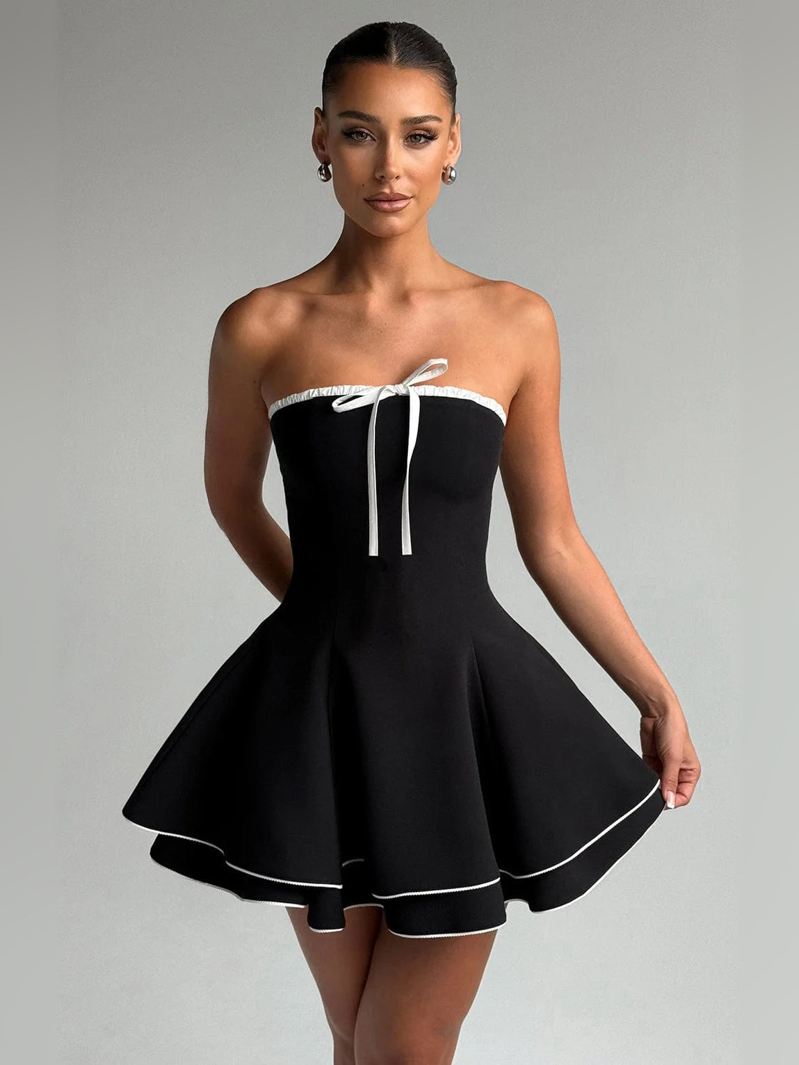 Mini homecoming dress: strapless black with white trim, ribbon tie at bust, flared skirt
