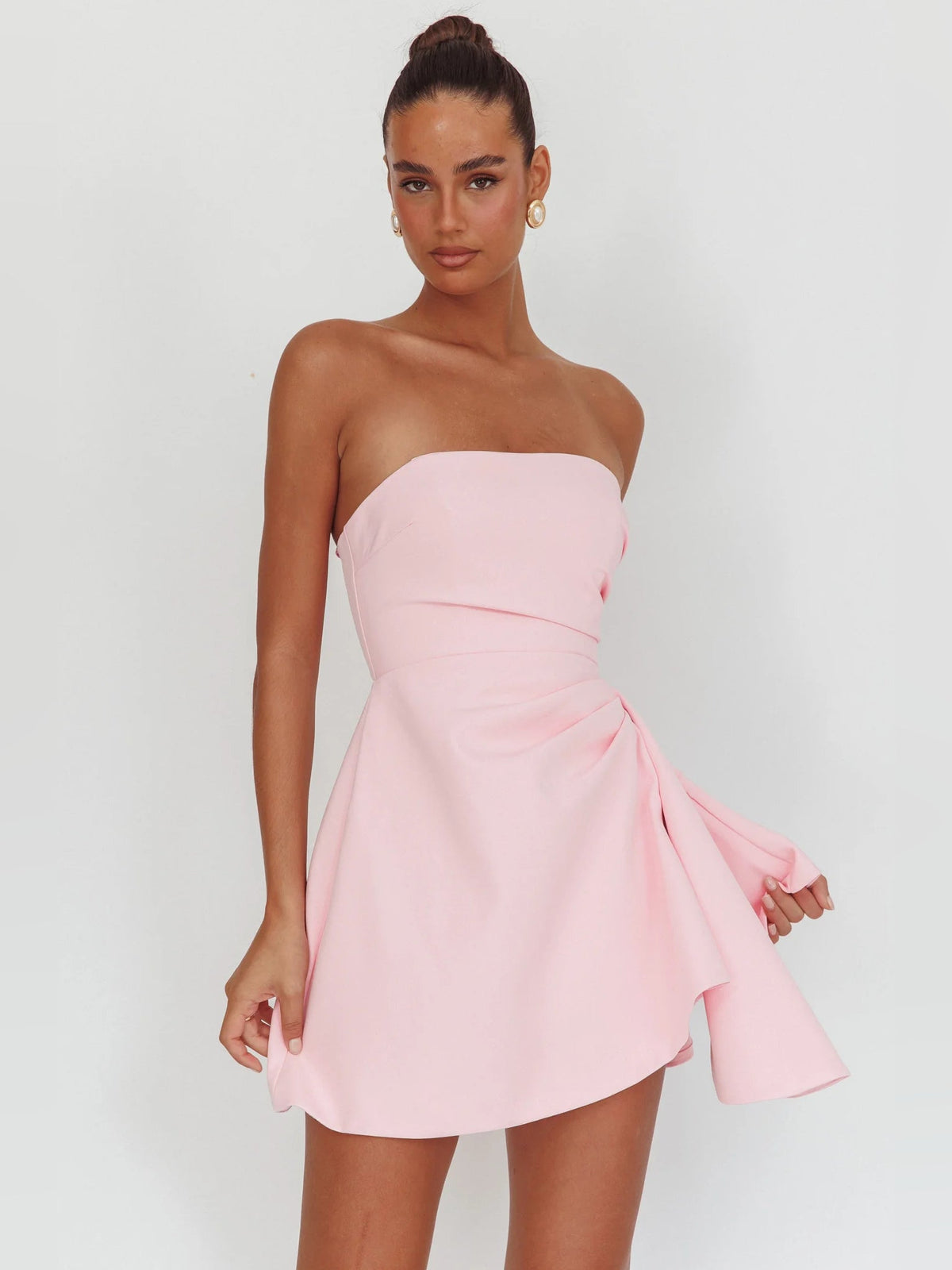 Pink strapless mini dress with ruched bodice and layered asymmetrical skirt
