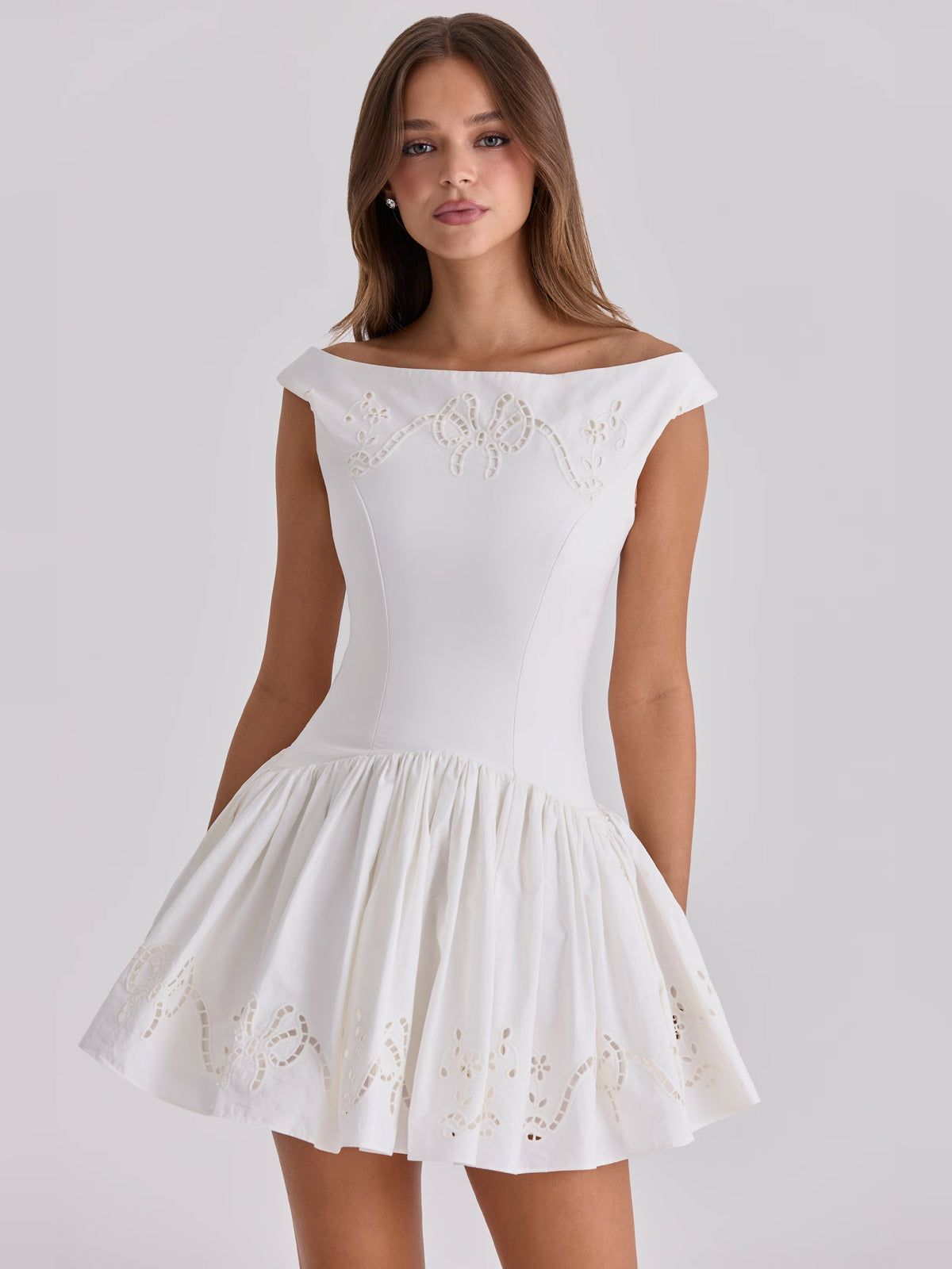 White boat-neck mini homecoming dress, sleeveless, embroidered bodice and flared skirt