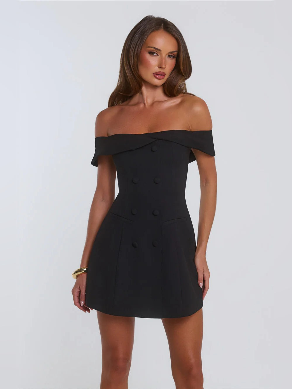Black off-shoulder mini homecoming dress, fitted bodice with double-button accents.