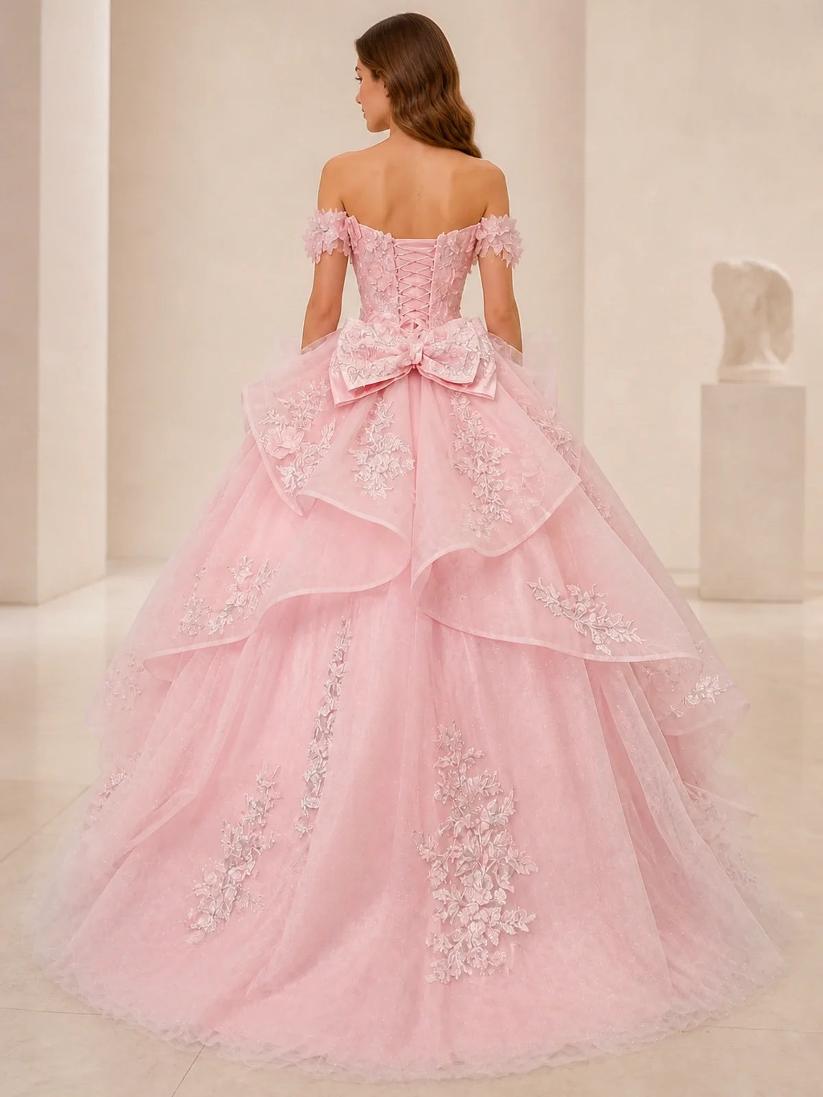 Pink off-shoulder tulle ball gown with floral lace appliques and back bow detail