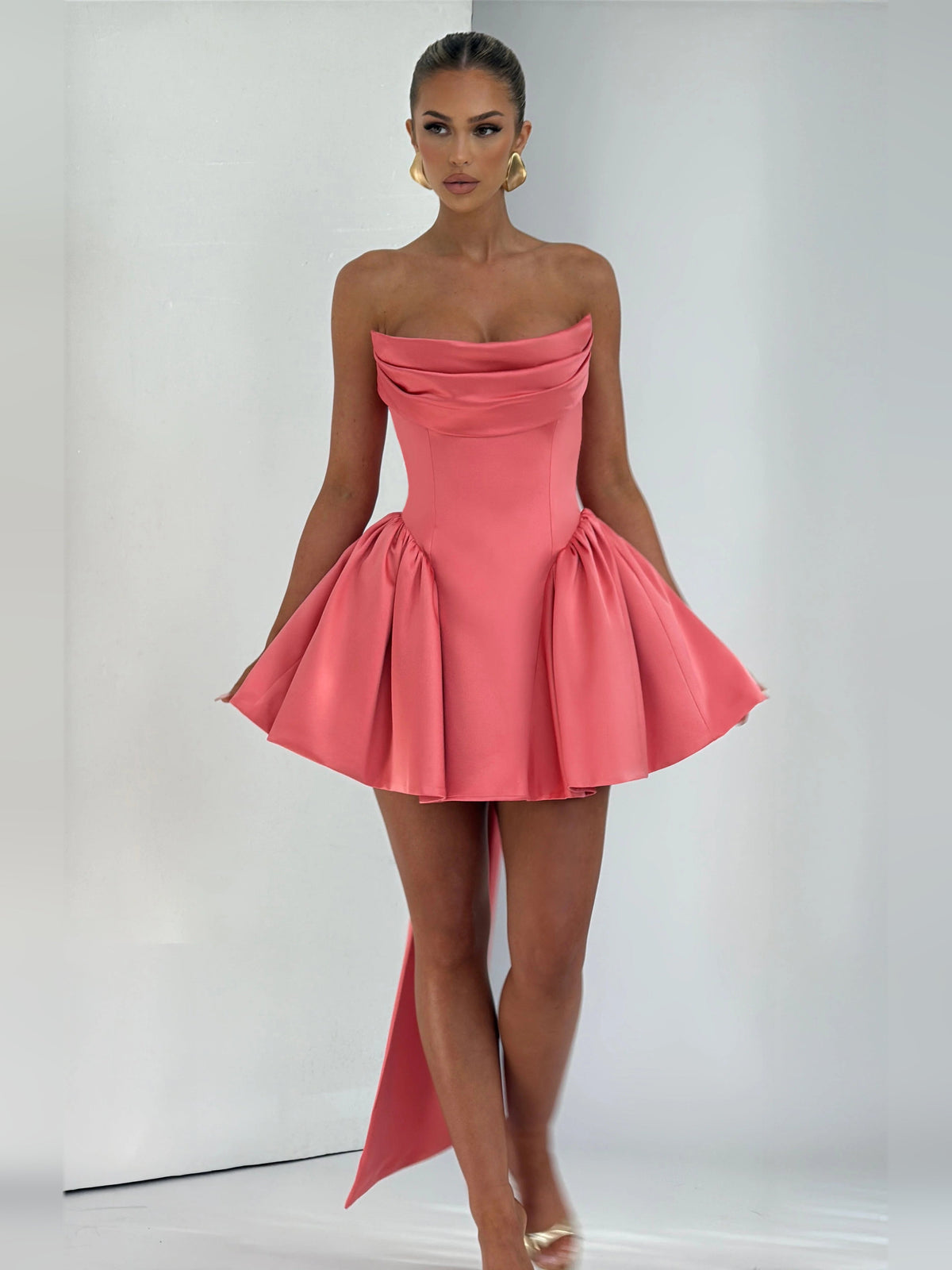 Pink strapless mini dress with draped bodice, flared skirt, long side ribbons