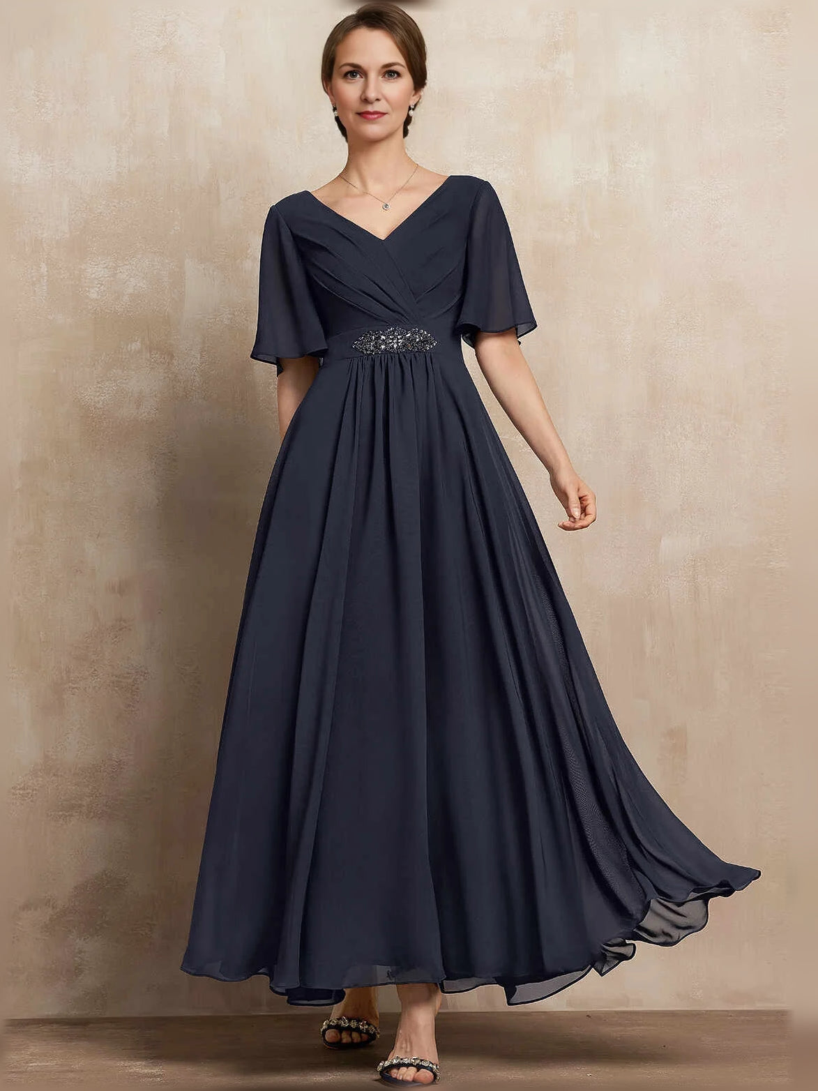 Dark navy chiffon maxi dress with V-neck, pleated skirt, flutter sleeves, and beaded waist