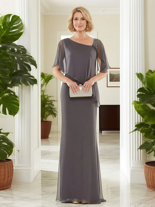 Grey sheath evening dress with beaded asymmetrical neckline and chiffon cape overlay