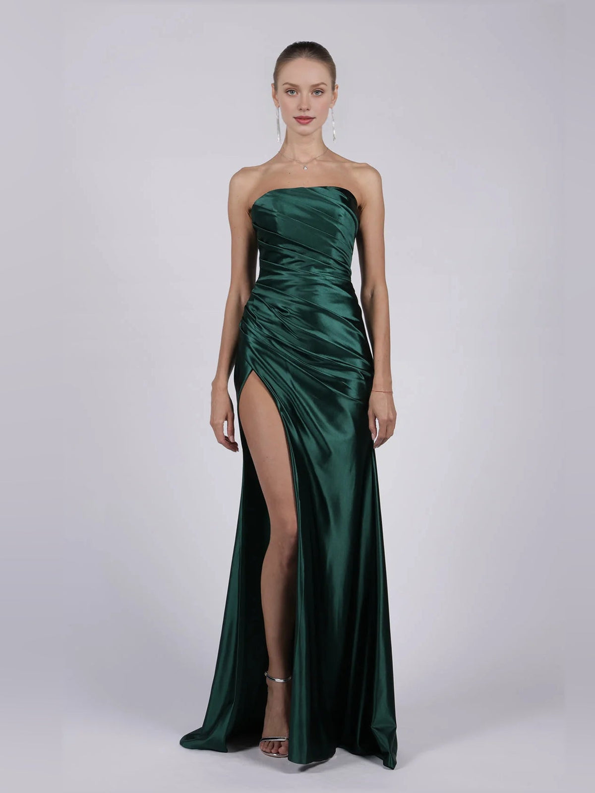 Strapless mermaid formal dress in dark green with ruched bodice and thigh slit