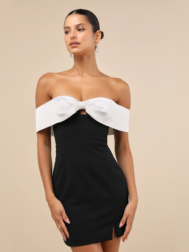 Black off-shoulder mini dress with white bow detail at neckline