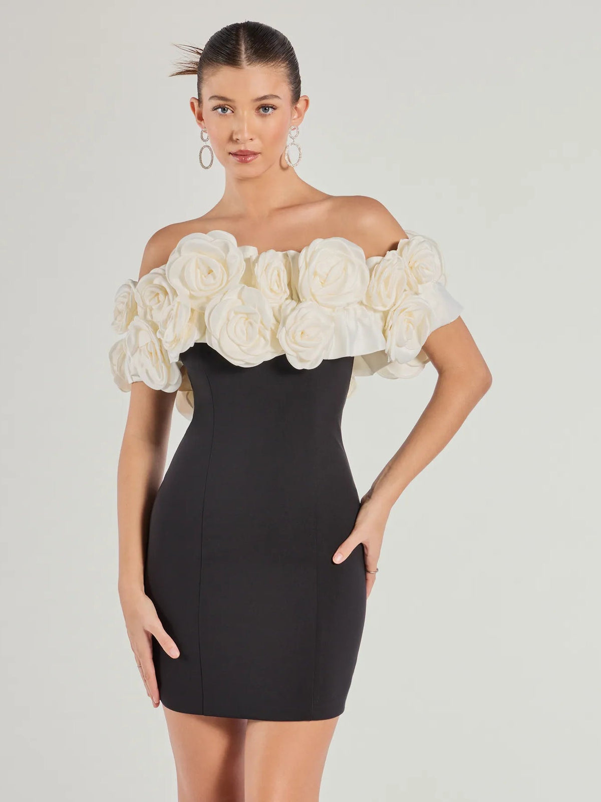 Black off-shoulder mini dress with cream rose rosette ruffle bodice