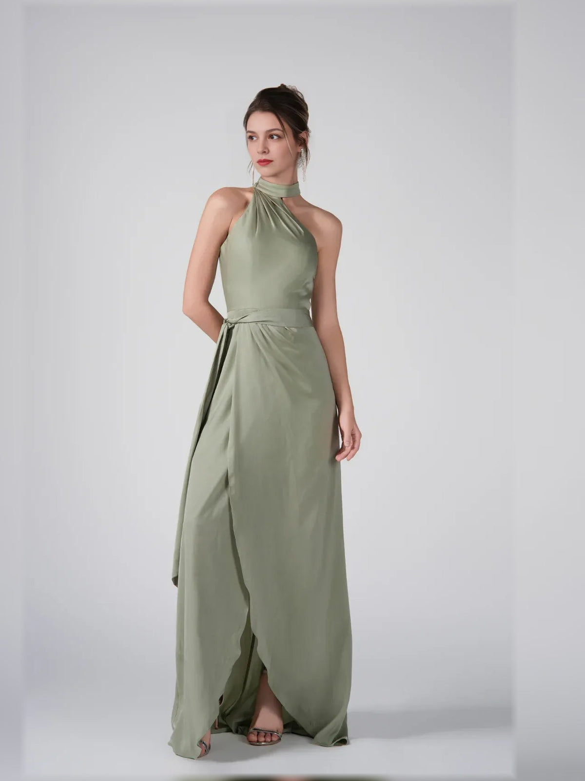 Dusty sage halter formal dress with open-back and front slit, floor-length.