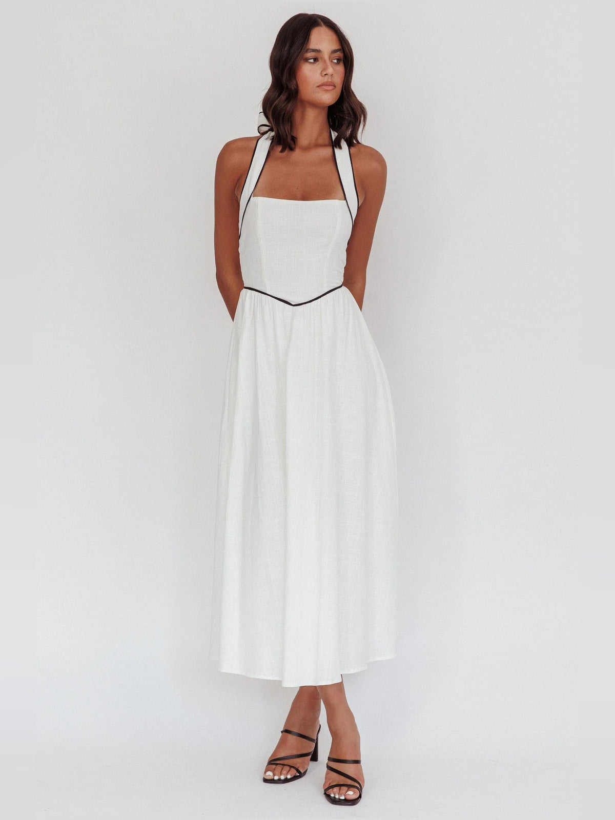 White a-line midi formal dress with halter neckline, full-length front view
