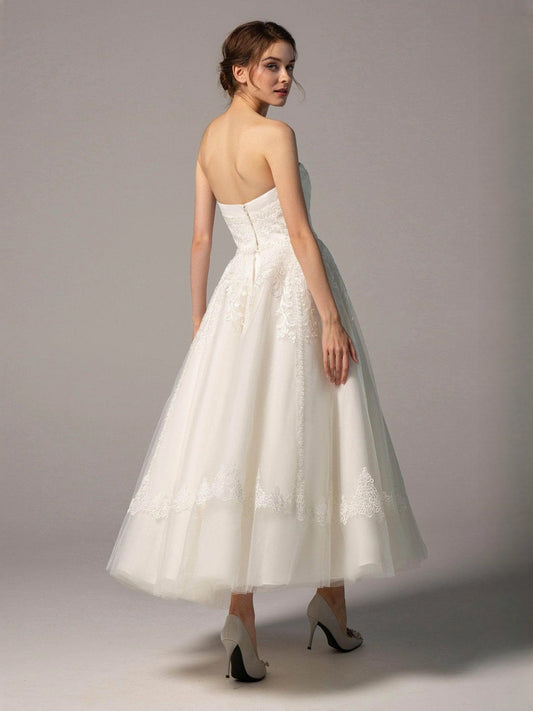 Ivory strapless A-line short wedding dress with lace overlay and sheer back detail