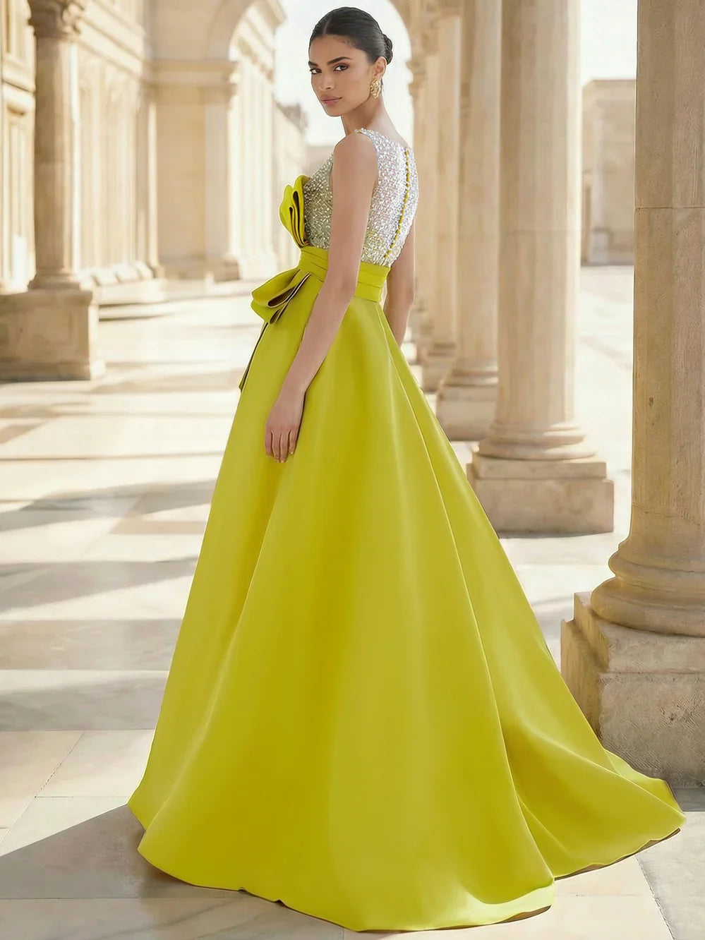 Yellow sleeveless sequin deep V-neck A-line gown with large waist bow, side view