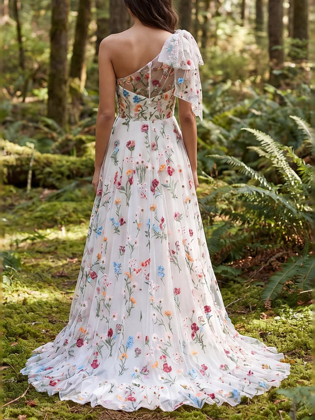 Ivory floral tulle gown with one-shoulder strap and flowing ruffled A-line skirt
