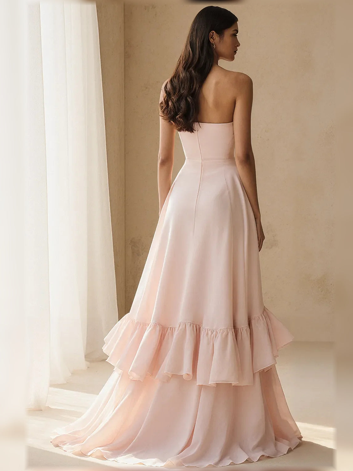 Strapless tiered ruffle A-line formal dress in light pink chiffon, back/side view