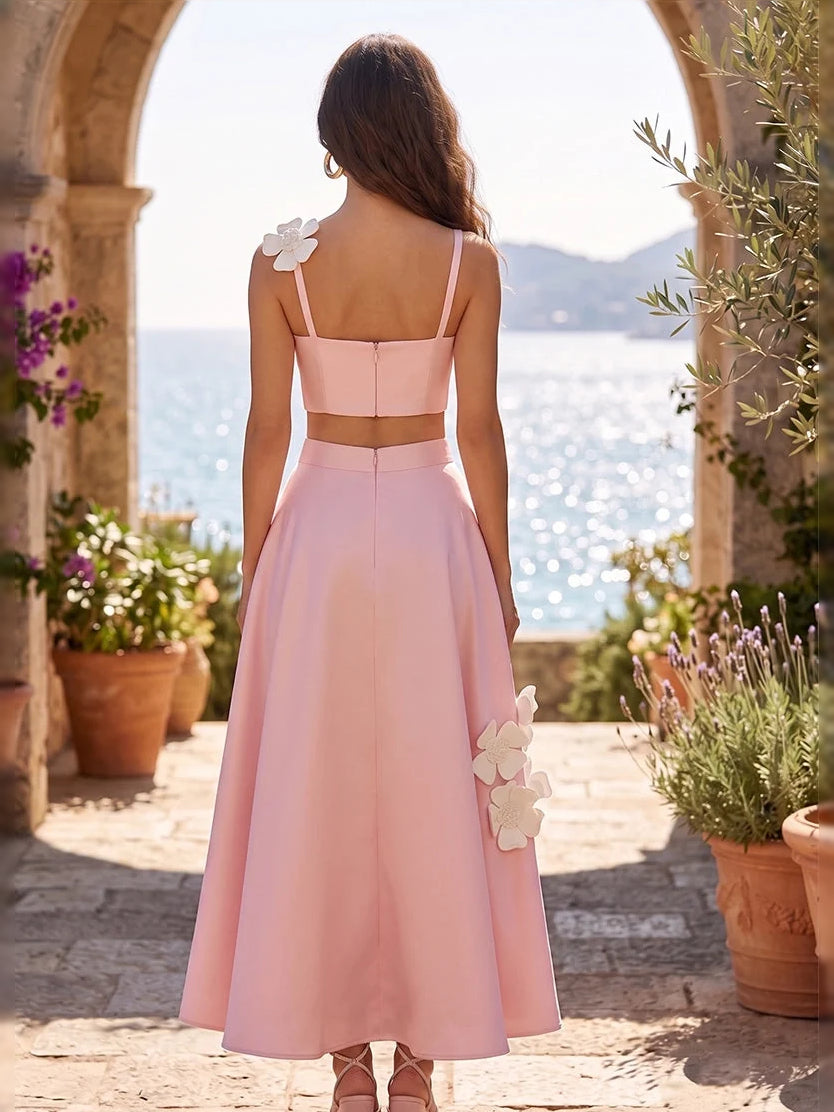 Light pink satin midi dress, open-back straps and white floral appliques at shoulders