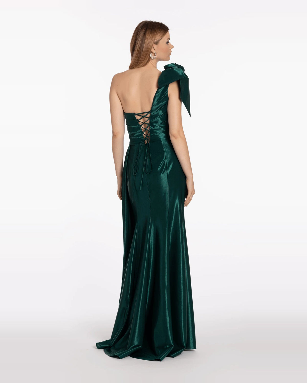 Back view of dark green satin trumpet maxi dress with lace-up back and bow shoulder