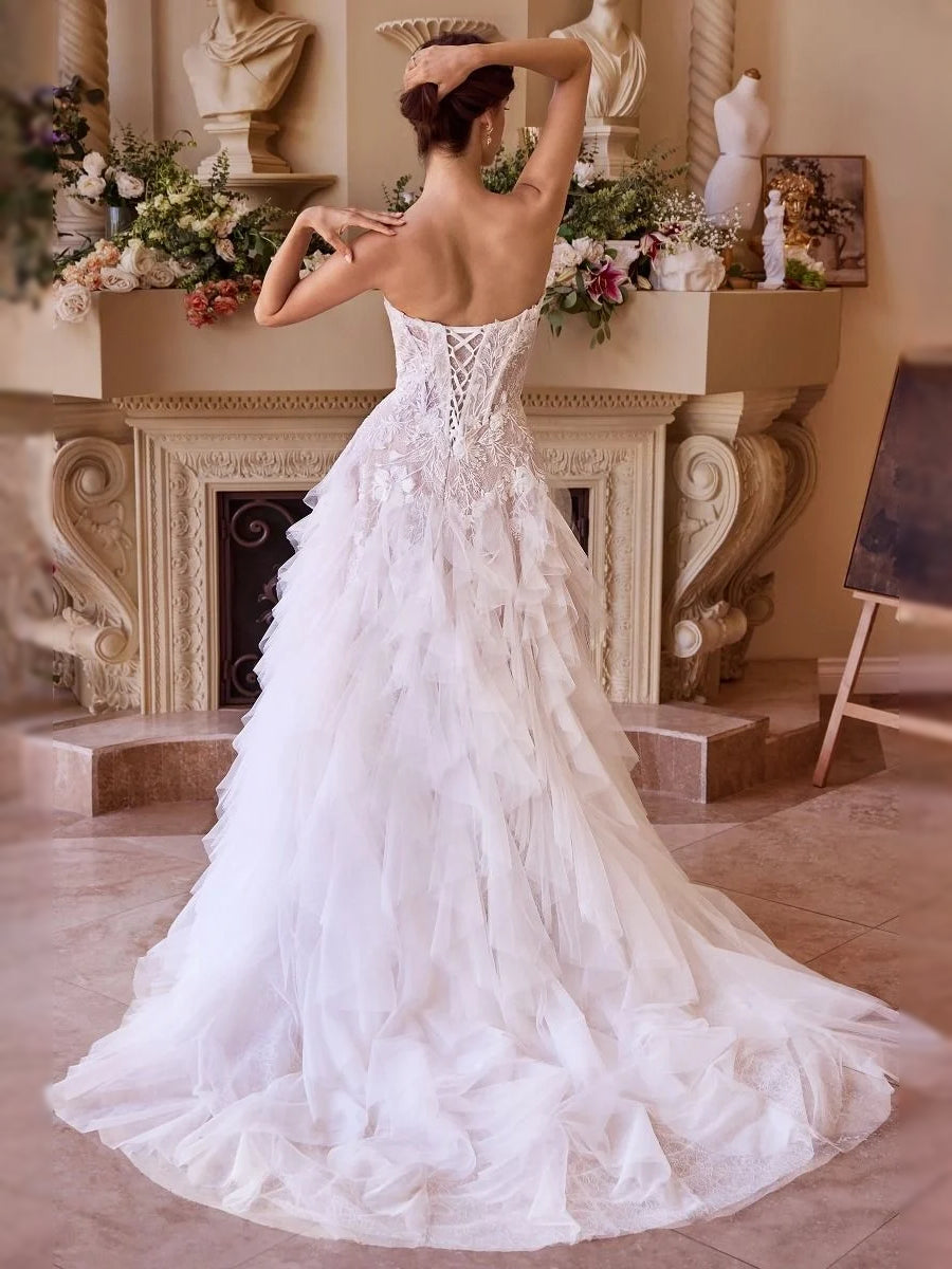 Ivory corset bodice backless A-line tulle wedding dress with layered ruffles, full length