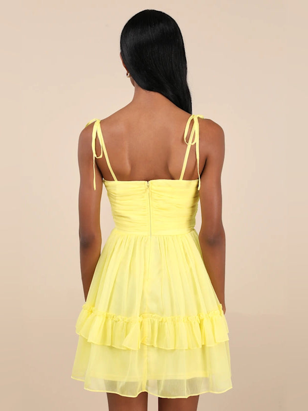 Yellow backless chiffon mini dress with tied spaghetti straps and tiered ruffles