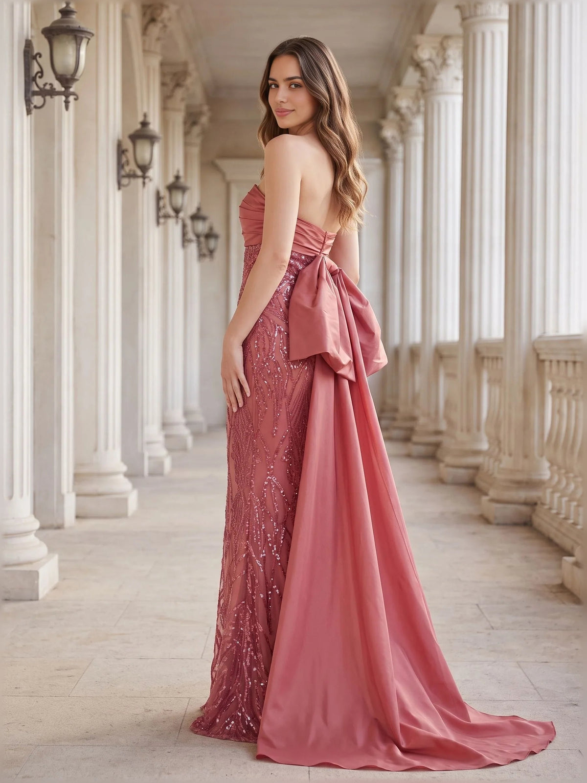Dusty rose strapless formal gown with open back and draped train, floor length