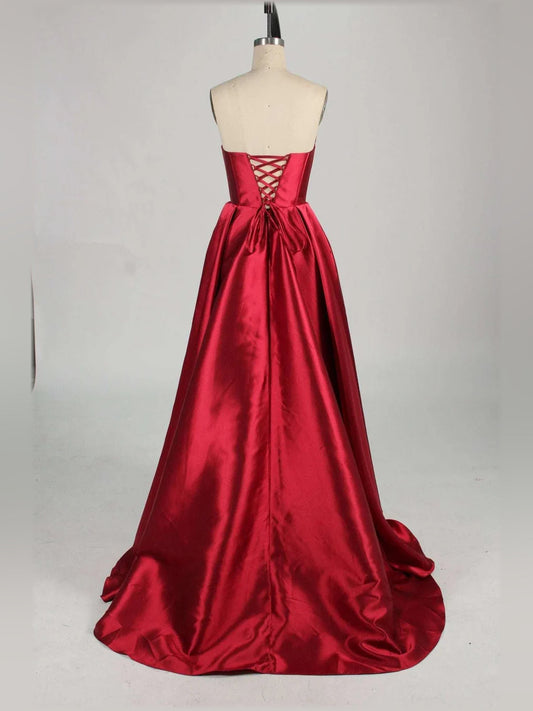 Red strapless corset formal dress on mannequin, lace-up back and full gathered skirt