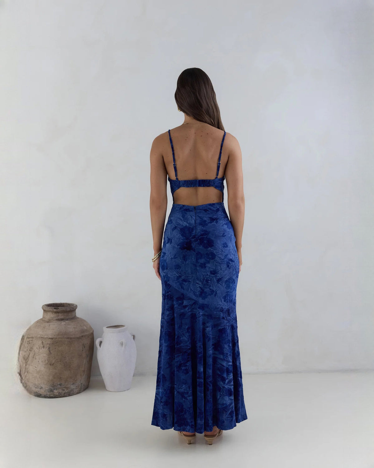 Back view of navy sleeveless mesh maxi dress with spaghetti straps and fitted A-line skirt.