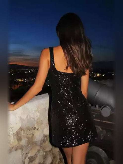 Back view of black sequin square-neck sleeveless mini dress with side slit