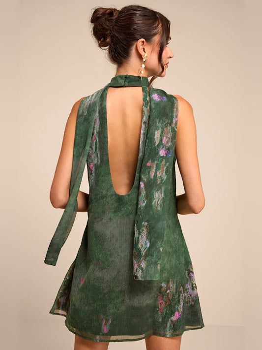 Green floral A-line mini dress showing open back with high halter neckline