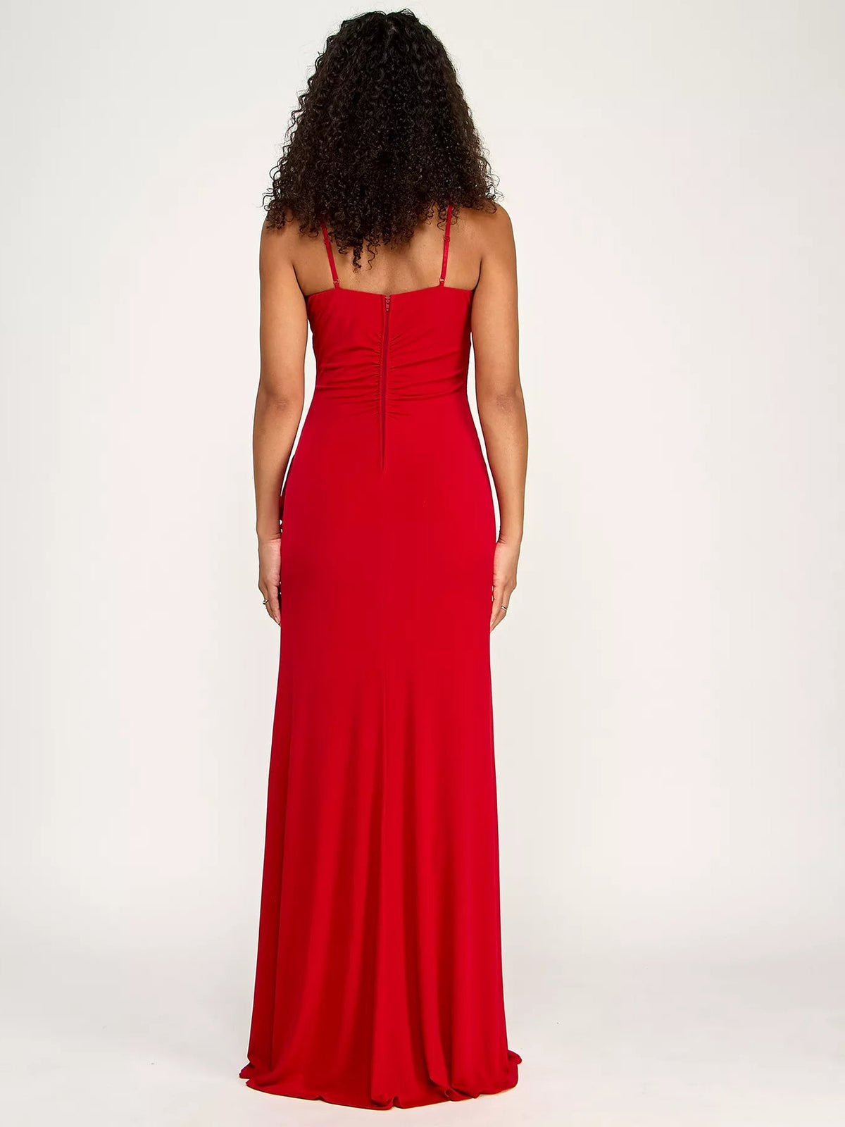 Red ruched-back formal gown with thin straps and floor-length skirt