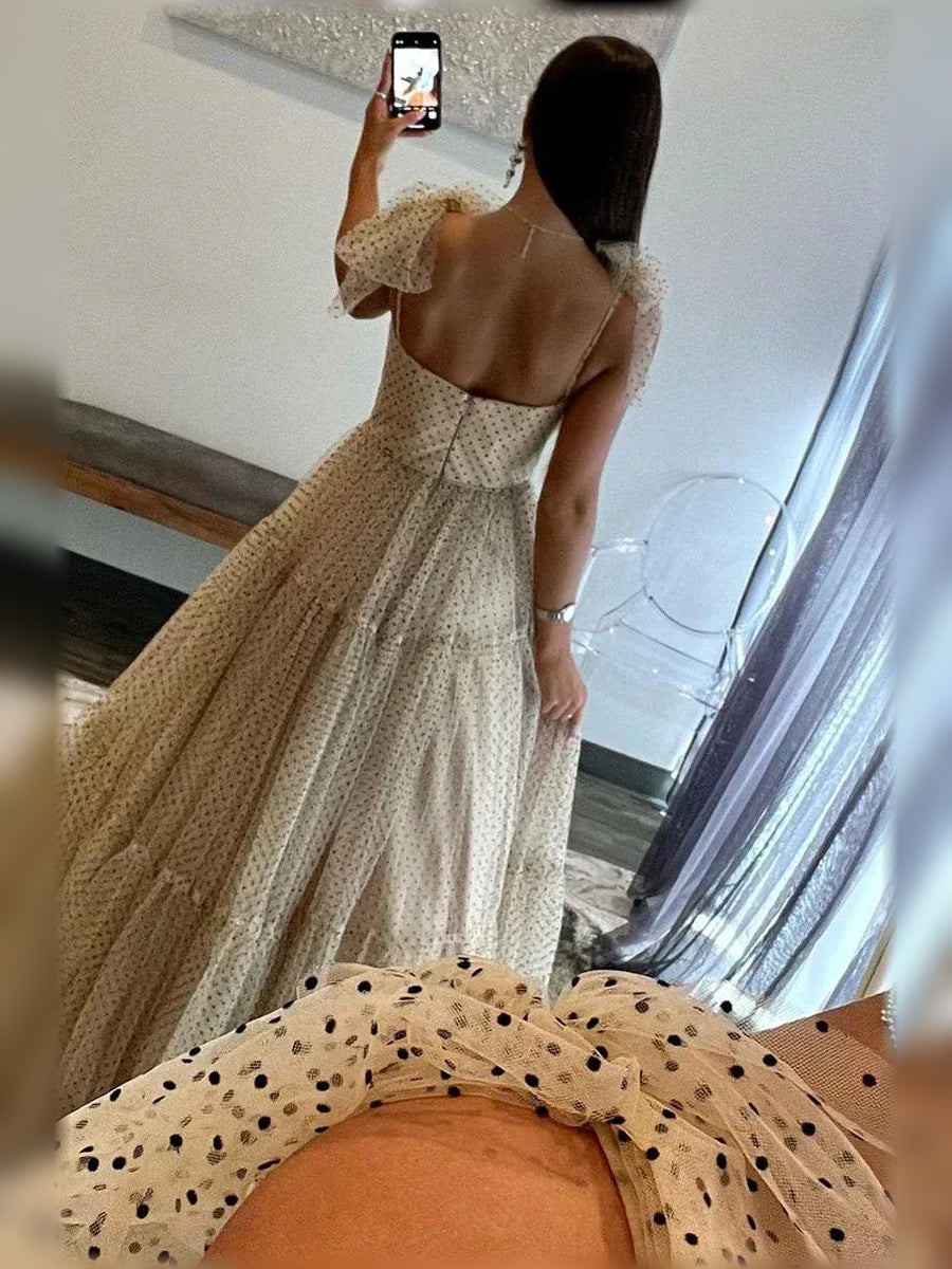 Champagne formal dress with tiered ruffles, open back, and dotted tulle texture