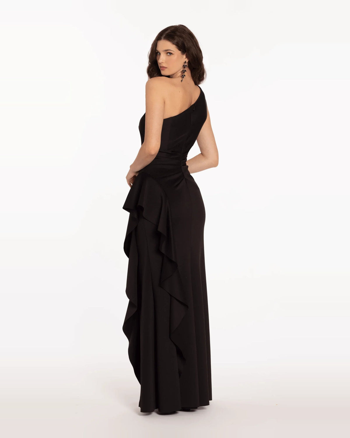 Black one-shoulder trumpet maxi dress with ruched bodice and layered ruffle panels