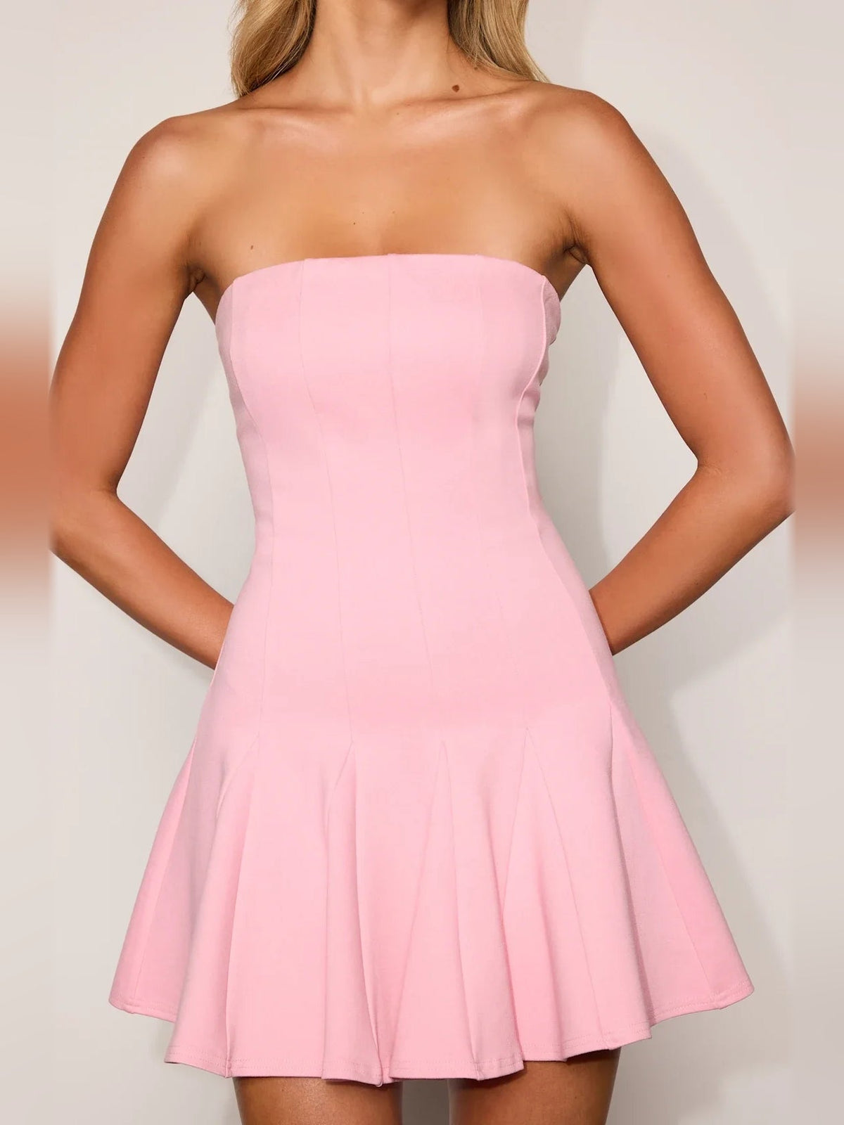 Light pink strapless fit-and-flare mini dress, sleeveless bodice with flared pleated hem