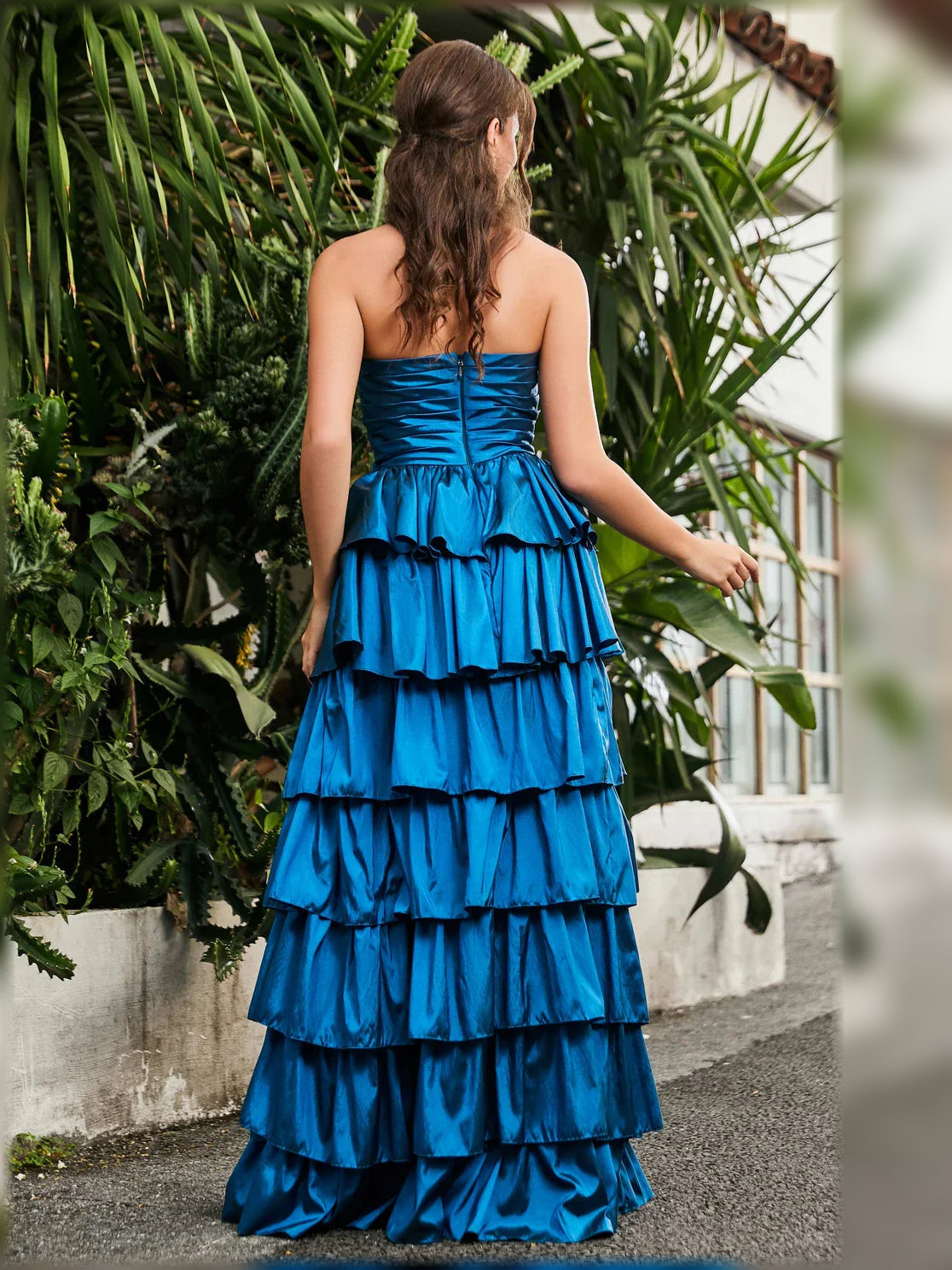 Blue strapless tiered formal dress from the back with layered ruffle skirt