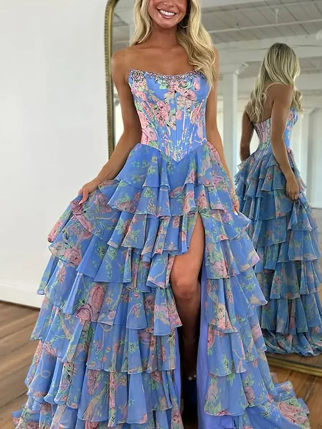 Blue floral tiered ruffle strapless A-line prom dress with front slit and layered skirt.