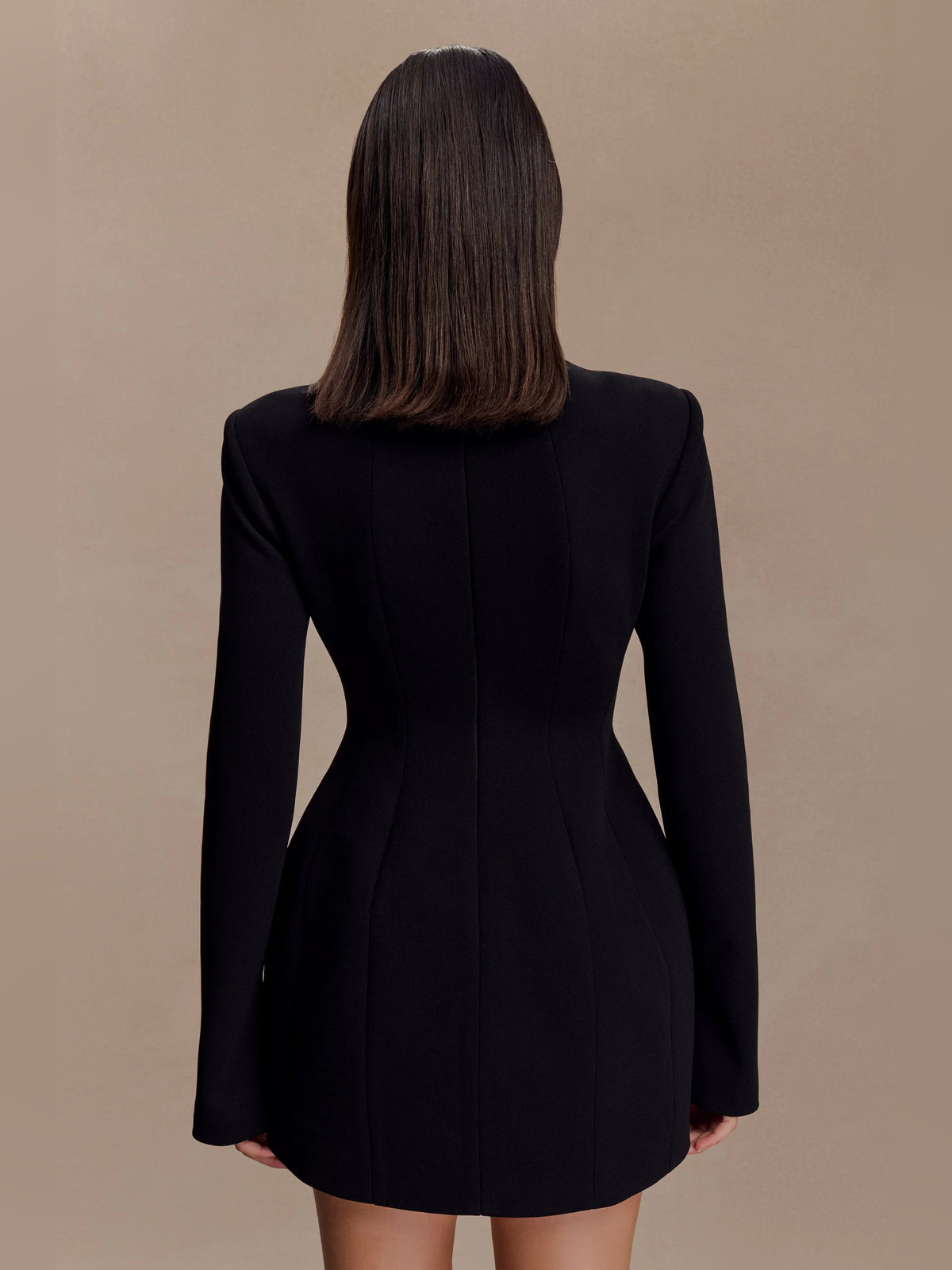 Black long-sleeve mini dress, back view with tailored seam and keyhole cut-out