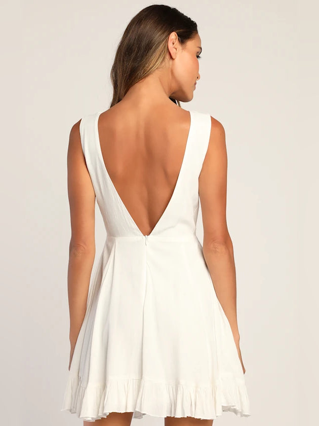 White sleeveless mini dress with open back and V-neck, tiered ruffle hem