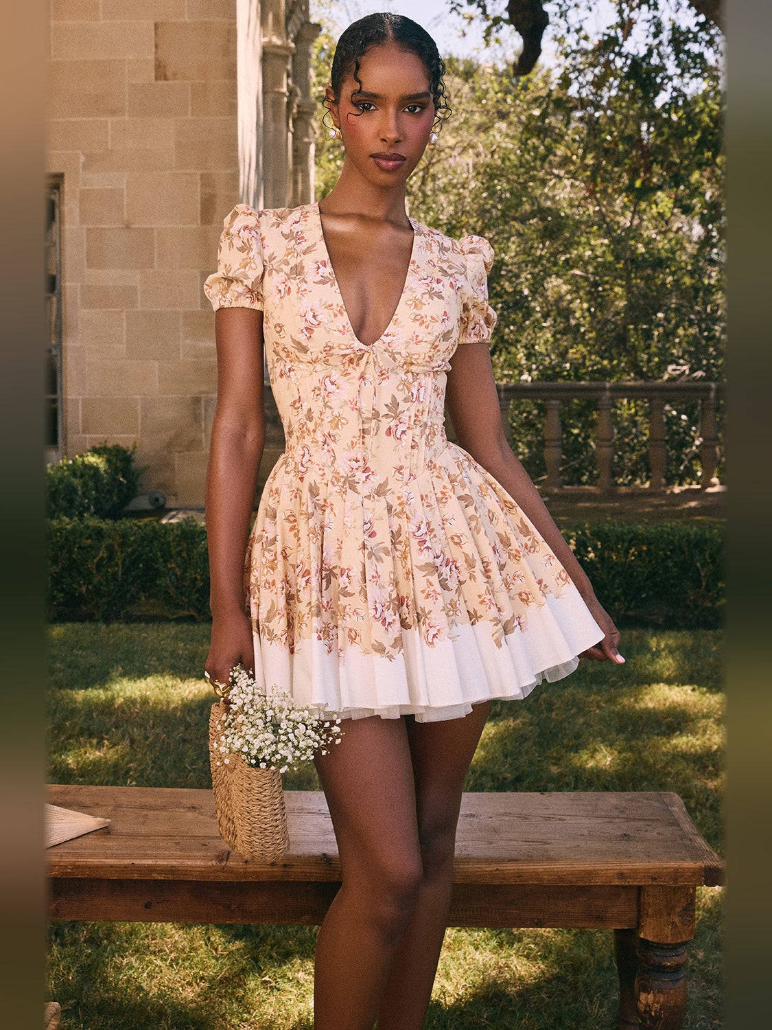 Floral pleated mini dress with puff sleeves, deep V-neck, and tiered white skirt